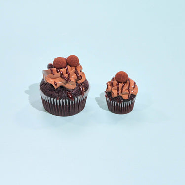 Chocolate Cupcakes by Crumbs & Doilies with rich sponge, smooth buttercream, ganache drizzle, and chocolate truffles on top.